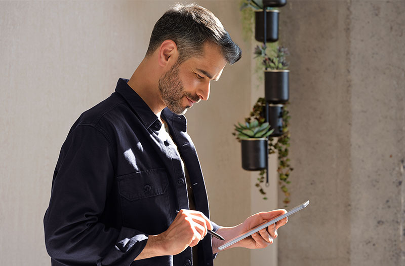 Man working on Microsoft Surface device