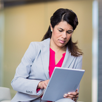 woman seriously pondering over her tablet