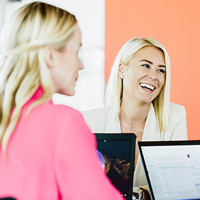 Small business employees candidly talking and laughing