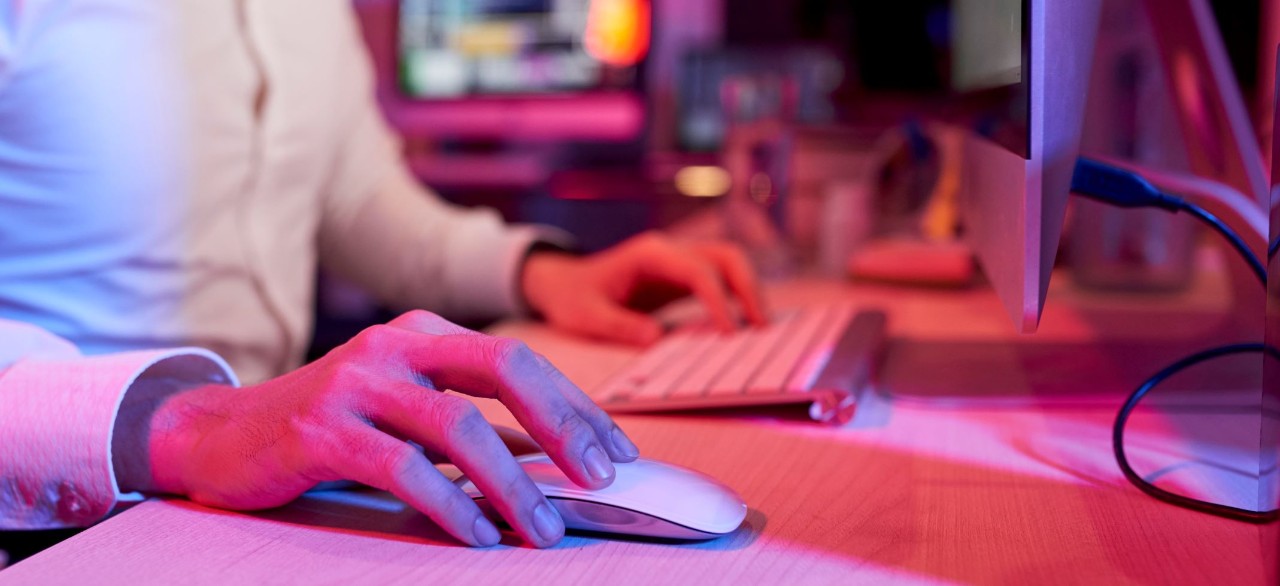 Business professionals using laptops in a modern office meeting