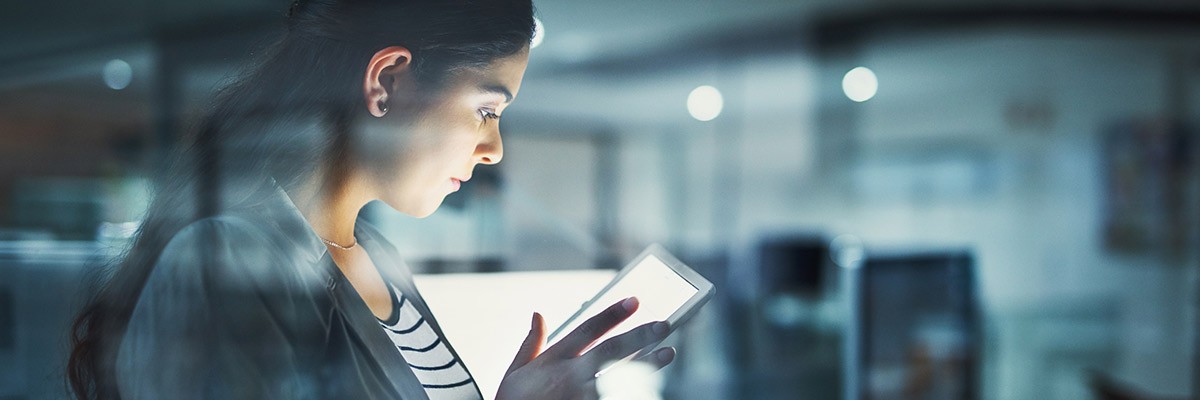 Woman on tablet at night