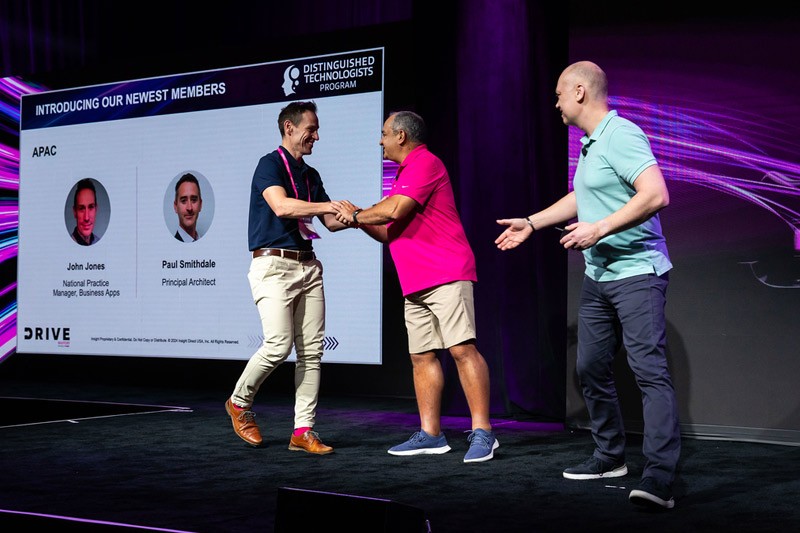 Meagan Gentry shakes hand with Juan Orlandini and Phil Hawkshaw at Insight Mastery event 2024