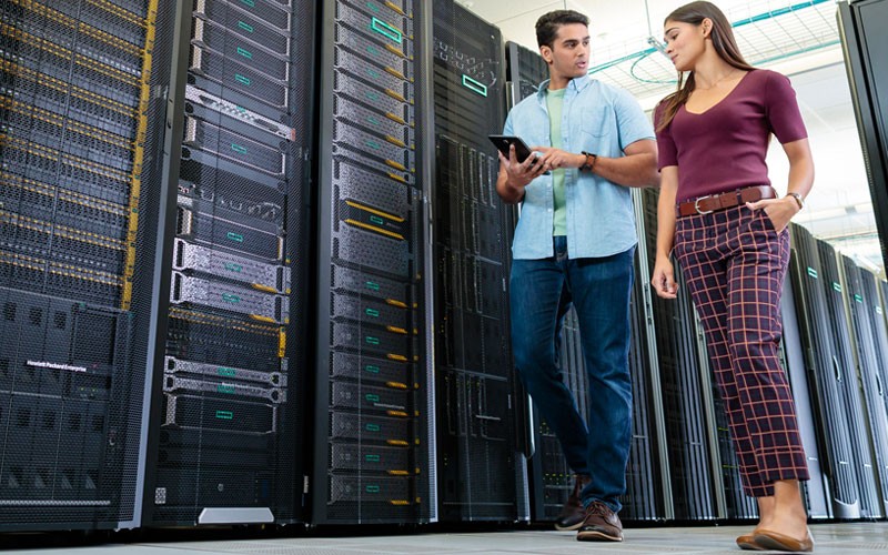 Two employees walking through server room