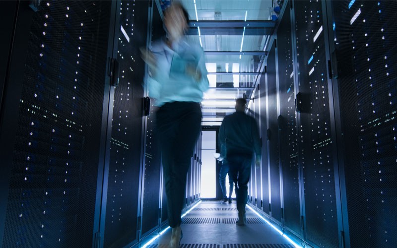 Two people walking through data center