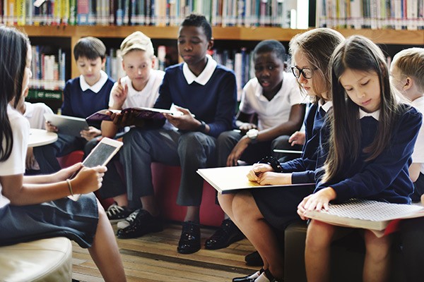 Children using their devices in a classroom