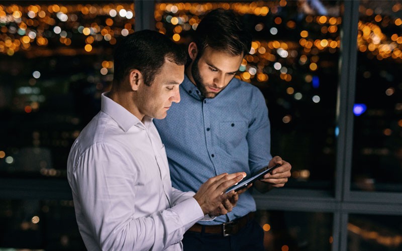 Two businessmen looking over tablet