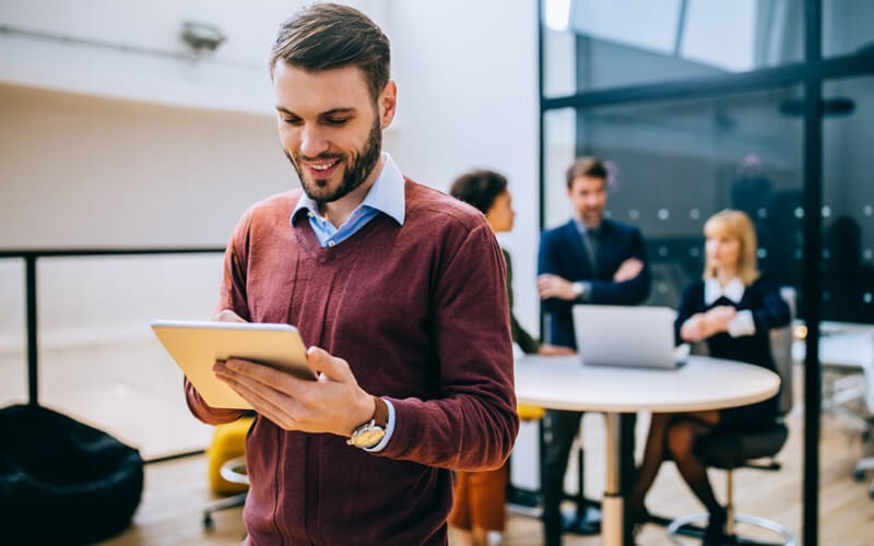 Smiling business man uses cloud technology in the office