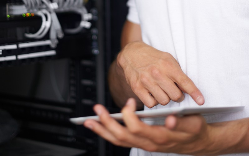 Close up of hands using tablet in data center