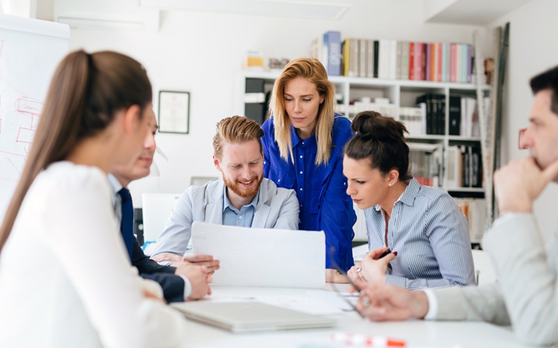 Teammates gathered around to discuss migration strategy 