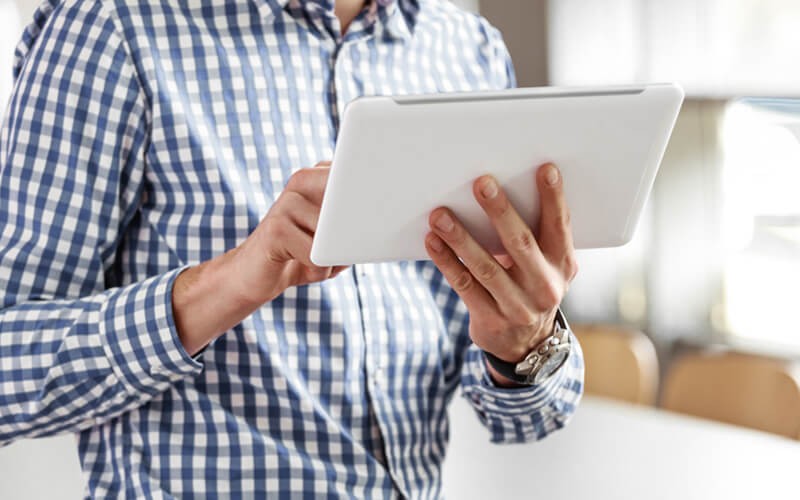 Man on tablet utilizing cloud technology