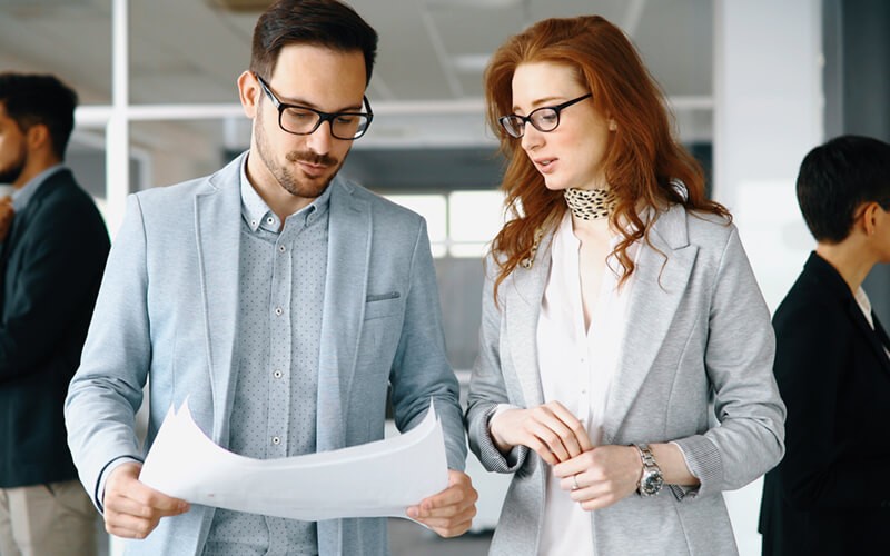 Two business professionals review strategy for converged infrastructures 