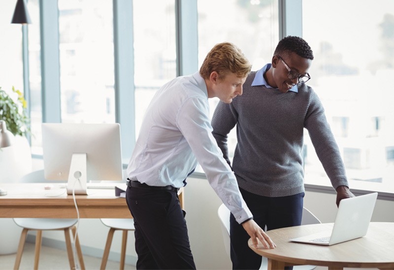 Two business women have discussion from thier notebook computer