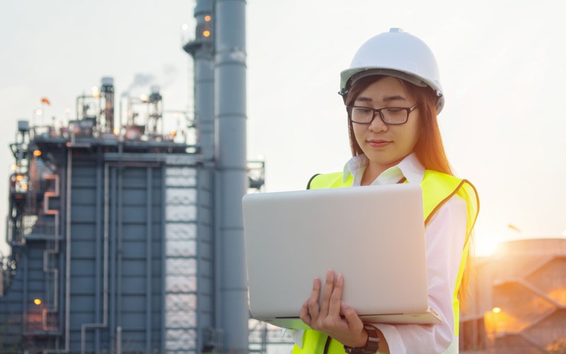 Business professional using laptop on site