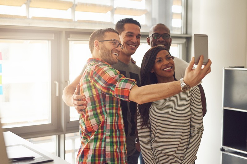 Group of entrepeneurs taking a selfie in the office.